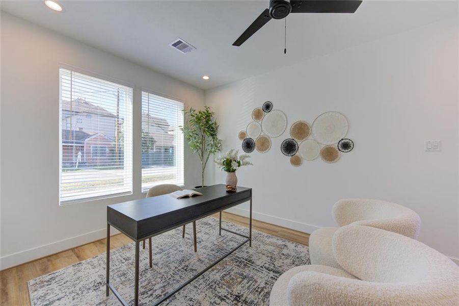 1st Floor Bedroom staged as a home office. Lots of natural light and a door leading to a fenced in backyard.