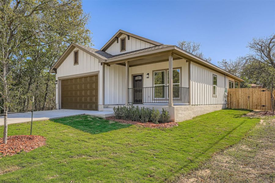 View of front of property with covered porch, and batten siding, a shingled roof, concrete driveway, and a front lawn View of front of property with covered porch, and batten siding, a shingled roof, concrete driveway, and a front lawn