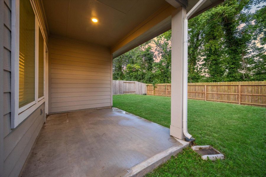 A generous covered patio creates the perfect space for grilling, relaxing, or enjoying a quiet evening. Overlooking a fully fenced backyard and lined by mature trees, this private outdoor area is a peaceful retreat with room to expand your lifestyle outdoors. A generous covered patio creates the perfect space for grilling, relaxing, or enjoying a quiet evening. Overlooking a fully fenced backyard and lined by mature trees, this private outdoor area is a peaceful retreat with room to expand your lifestyle outdoors.