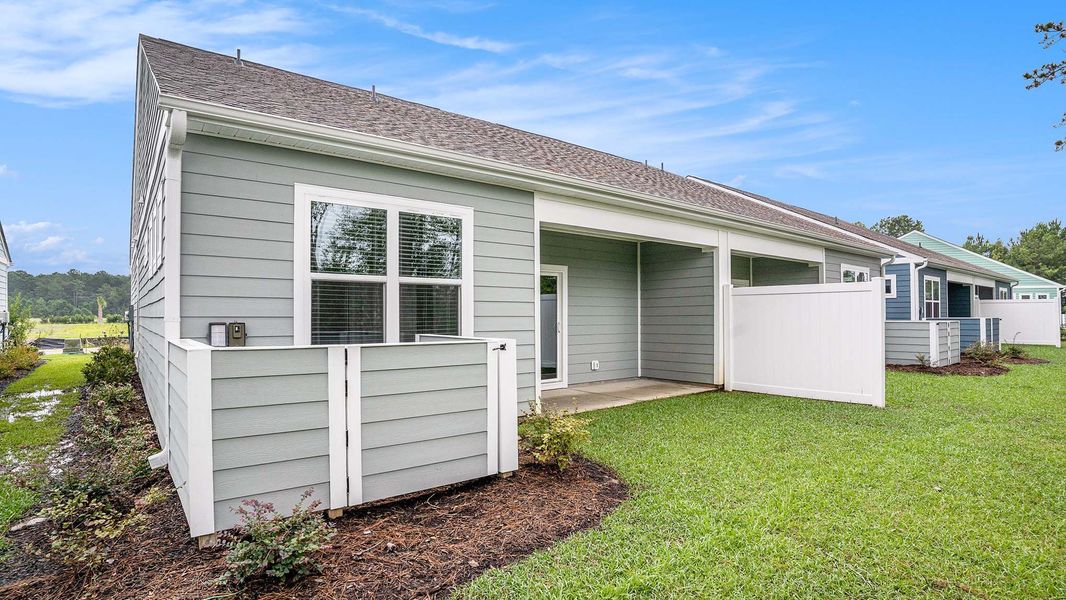 Exterior details and patio area of a home in Rich Square at Brunswick Plantation, Ash (Image 14). Exterior details and patio area of a home in Rich Square at Brunswick Plantation, Ash (Image 14).