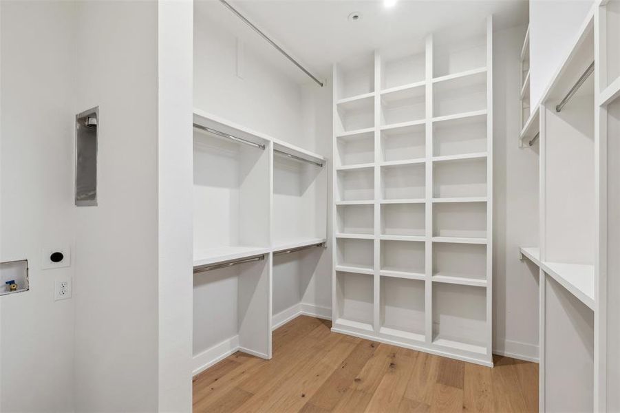 Primary walk-in closet with stackable washer/dryer hookups.