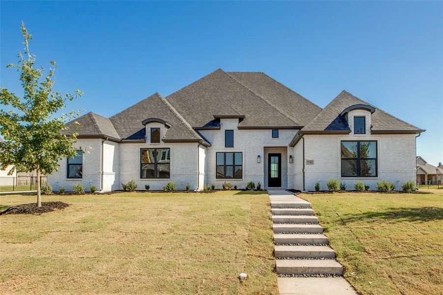 French country home with a front lawn