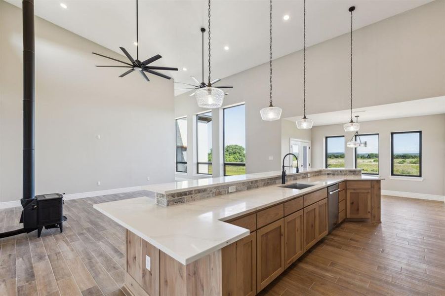 Kitchen featuring a sink, open floor plan, island, dishwasher, high vaulted ceiling, ample counter space Kitchen featuring a sink, open floor plan, island, dishwasher, high vaulted ceiling, ample counter space