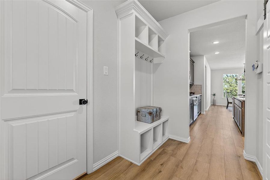 Mudroom featuring light wood finished floors, recessed lighting, and a chandelier Mudroom featuring light wood finished floors, recessed lighting, and a chandelier