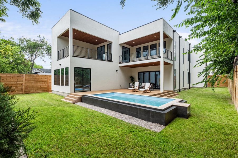 Modern architecture meets outdoor leisure with a sleek swimming pool and inviting deck. Modern architecture meets outdoor leisure with a sleek swimming pool and inviting deck.