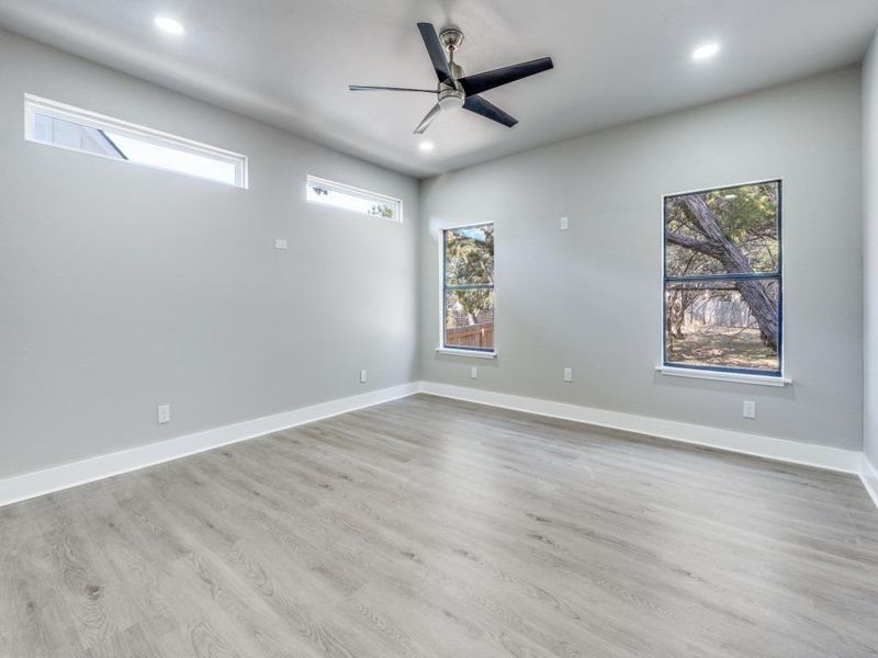 Empty room featuring ceiling fan, recessed lighting, and light wood-style floors