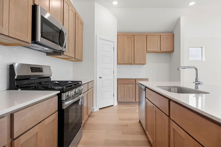 Kitchen in the Sabine home plan by Trophy Signature Homes – REPRESENTATIVE PHOTO