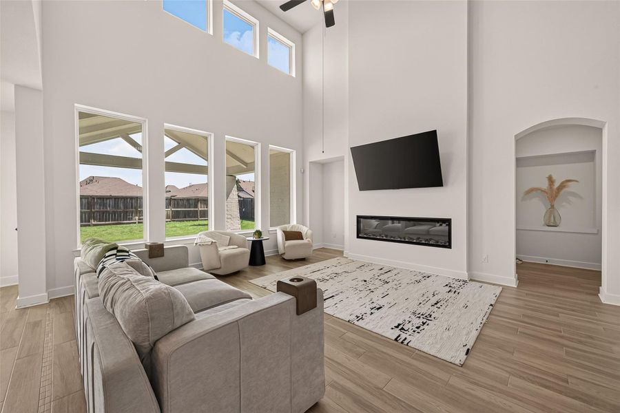 The spacious family room features soaring ceilings and a beautiful fireplace. The spacious family room features soaring ceilings and a beautiful fireplace.