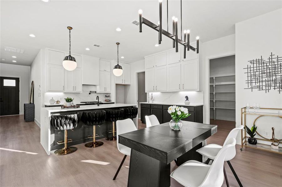 Dining room with wood finished floors and recessed lighting
