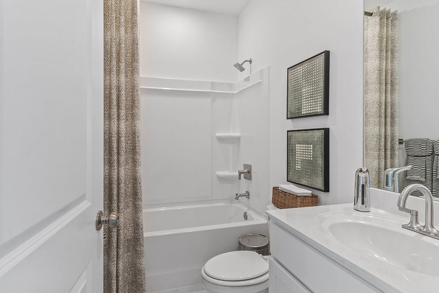 A bathroom with a tub sink and toilet.