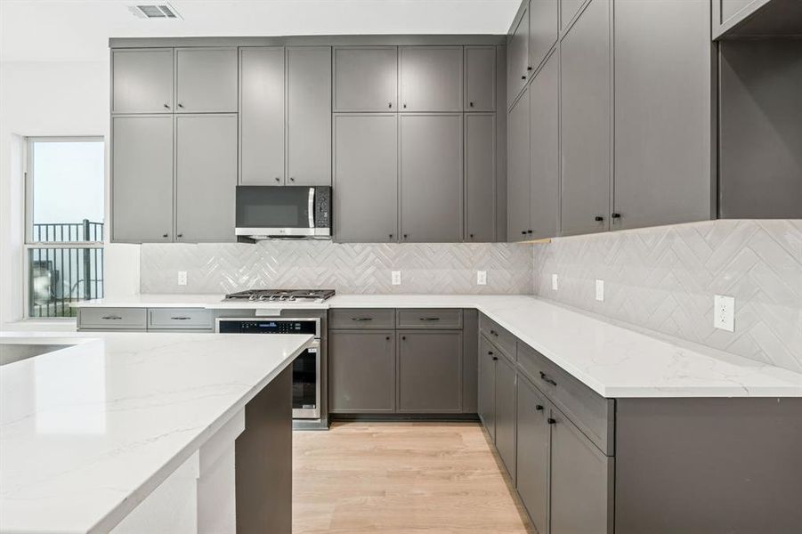 Sleek cabinets and backsplash.