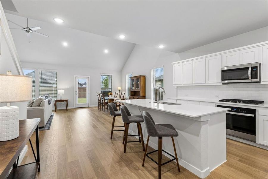 Kitchen with island, gas cooktop, stainless steel appliances Kitchen with island, gas cooktop, stainless steel appliances
