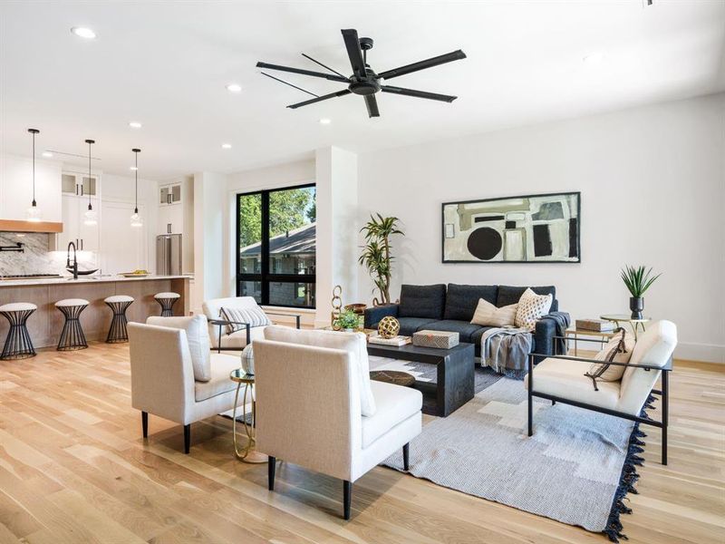 Living area with light wood-style floors, recessed lighting, and ceiling fan
