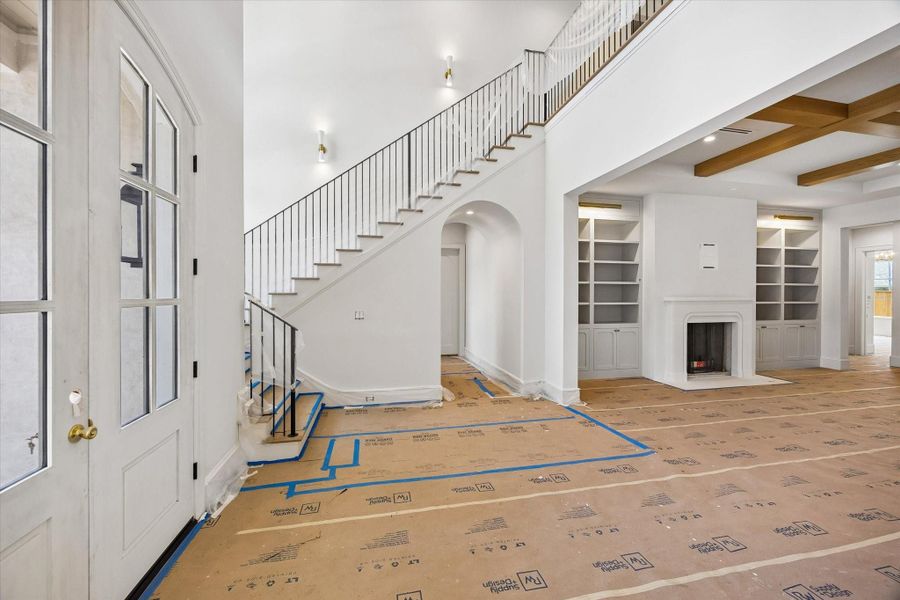 Just off the foyer, an arched hallway leads to the study and powder room.