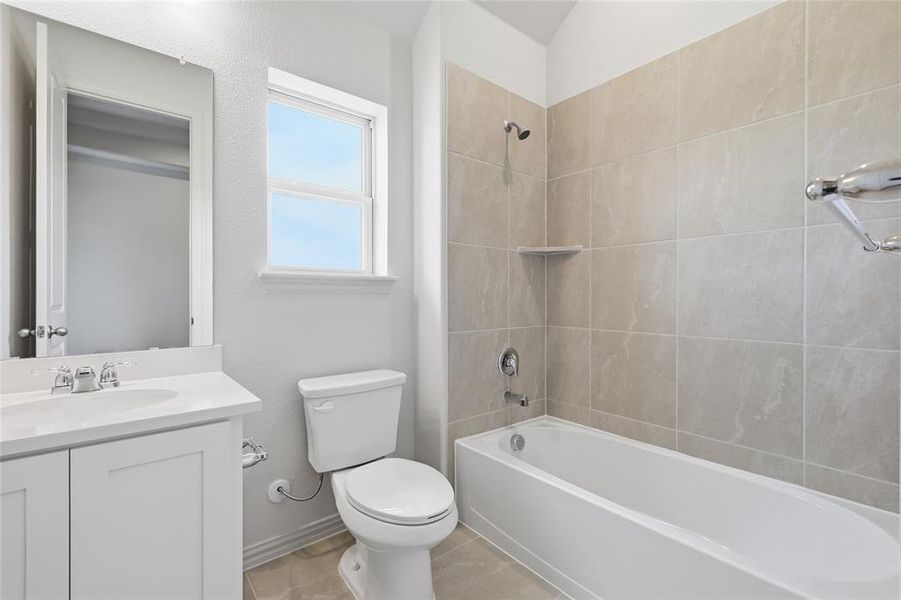 Bathroom featuring vanity and  shower combination