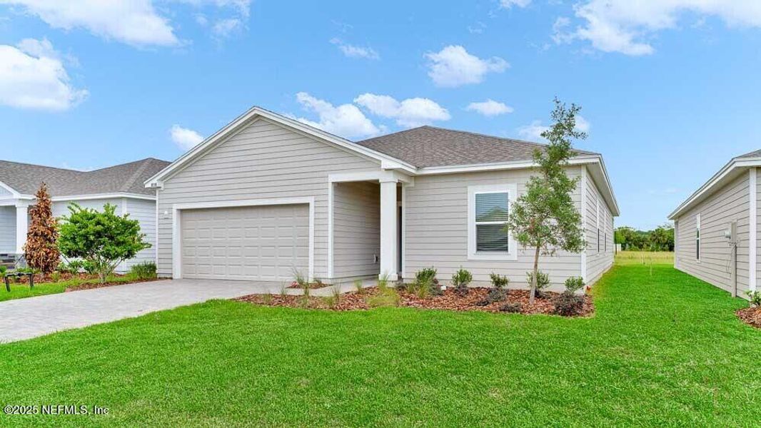 Front exterior of a new home in Coopers Meadow, Jacksonville, FL, highlighting curb appeal (Image 1).