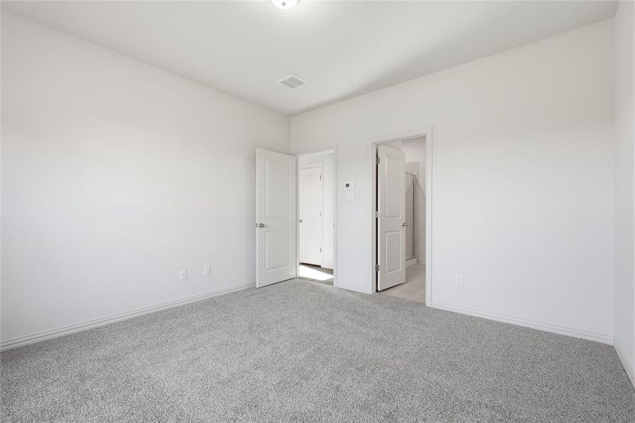 Carpeted room with light gray walls, white trim, and a ceiling-mounted light fixture