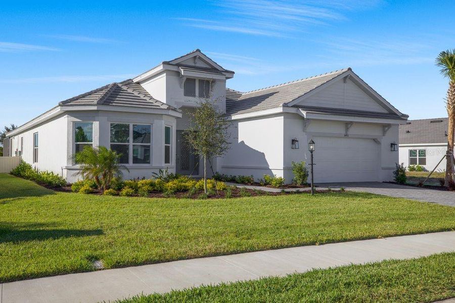 Front exterior of a new home in Esplanade at Azario Lakewood Ranch, Bradenton, FL, highlighting curb appeal (Image 2). Front exterior of a new home in Esplanade at Azario Lakewood Ranch, Bradenton, FL, highlighting curb appeal (Image 2).