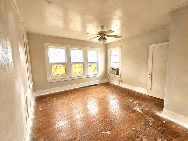 Spare room with cooling unit, ceiling fan, and dark wood-type flooring Spare room with cooling unit, ceiling fan, and dark wood-type flooring
