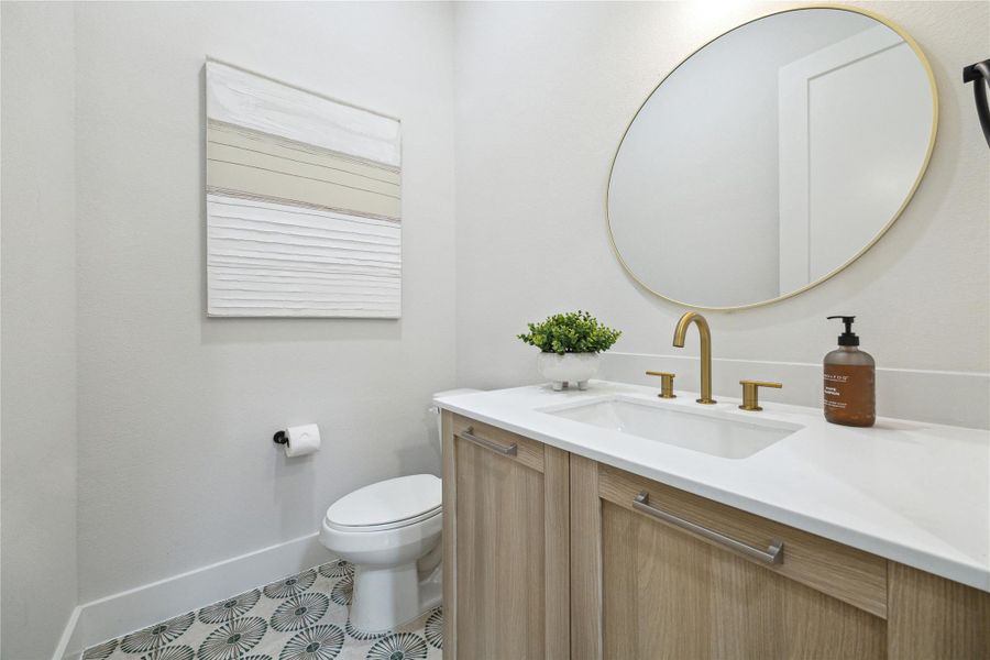 Chic powder room featuring modern fixtures, elegant vanity, and stylish tile flooring. Perfect blend of functionality and design.