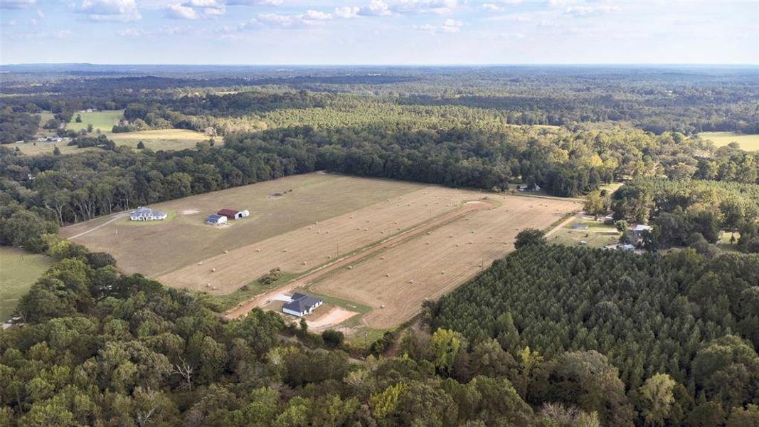 Aerial overview of property's location with a forest and rural landscape Aerial overview of property's location with a forest and rural landscape