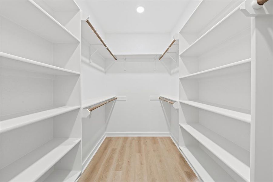 Spacious closet with light wood finished floors Spacious closet with light wood finished floors