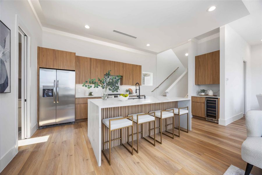 Off of the kitchen you have a sophisticated dry bar, complete with a built-in beverage fridge.