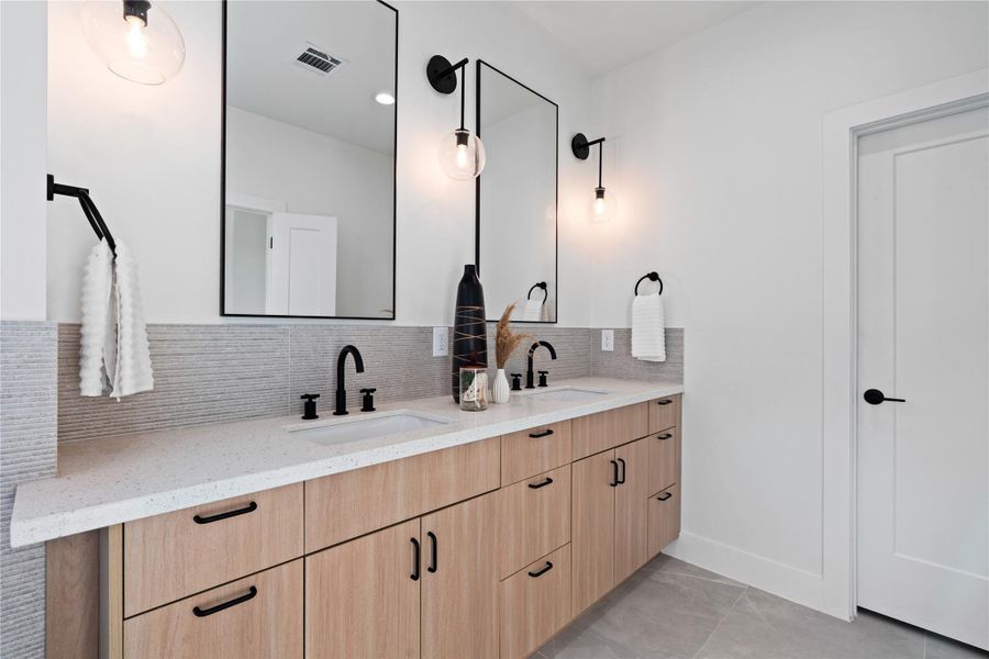 The primary ensuite offers generous counter space and abundant storage, thoughtfully designed for both you and your spouse. Every item has its place, keeping the space organized and functional without sacrificing style. This blend of practicality and elegance makes daily routines effortless and enjoyable