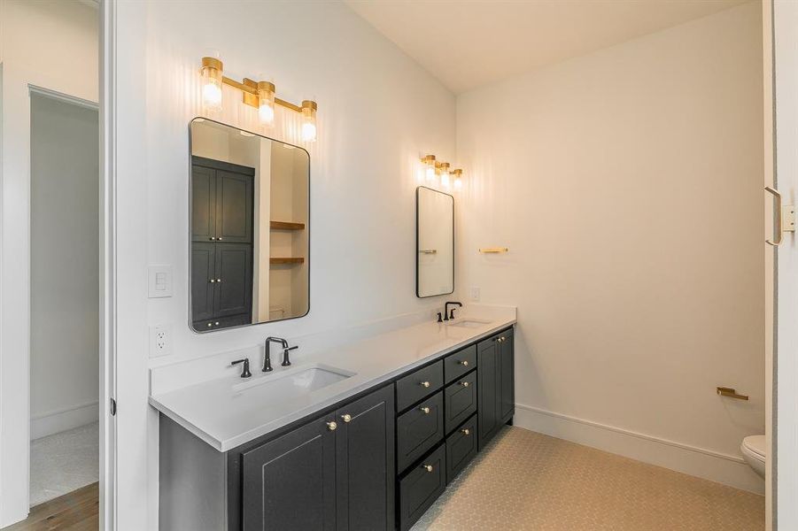 Bathroom with double vanity and toilet