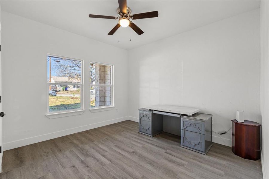 Unfurnished office featuring ceiling fan and light hardwood / wood-style flooring