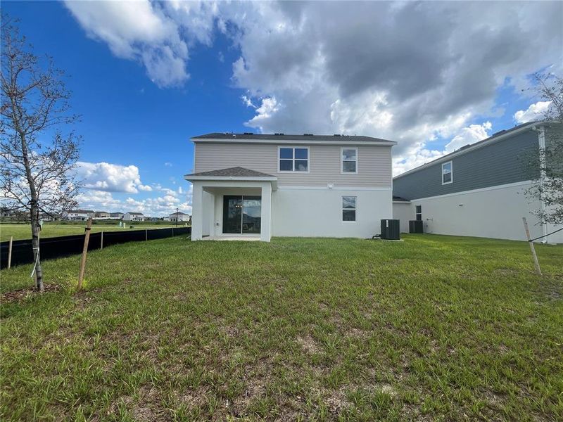Front exterior of a new home in Trinity Lakes, Groveland, FL, highlighting curb appeal (Image 2). Front exterior of a new home in Trinity Lakes, Groveland, FL, highlighting curb appeal (Image 2).