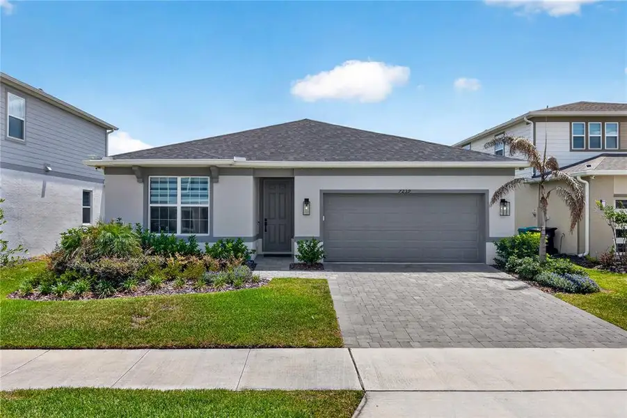 Front exterior of a new home in EverBe, Orlando, FL, highlighting curb appeal (Image 2). Front exterior of a new home in EverBe, Orlando, FL, highlighting curb appeal (Image 2).