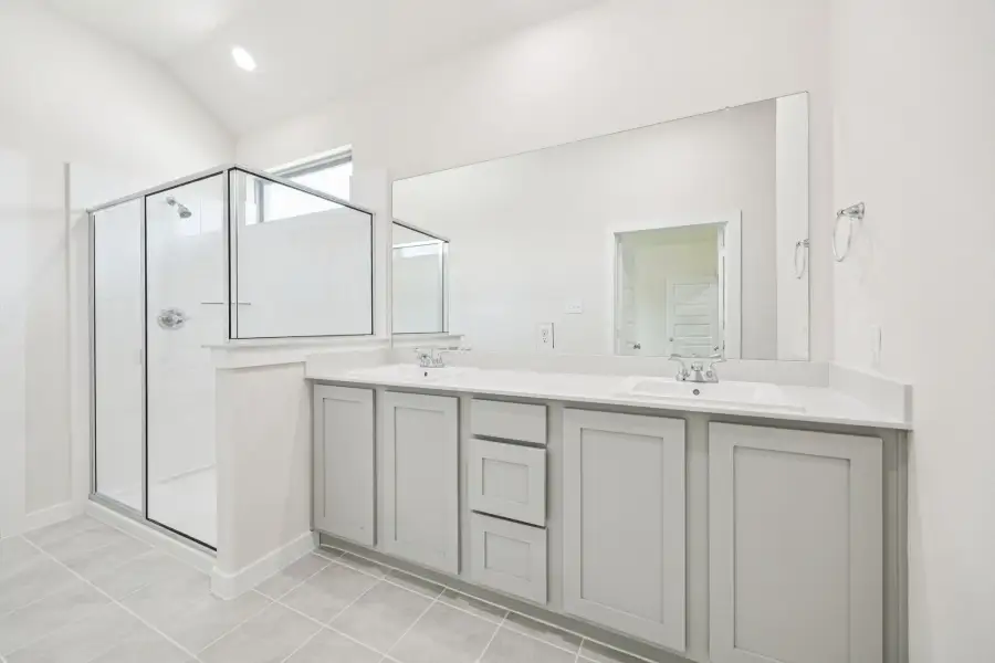 Primary Bathroom in the Claret home plan by Trophy Signature Homes – REPRESENTATIVE PHOTO