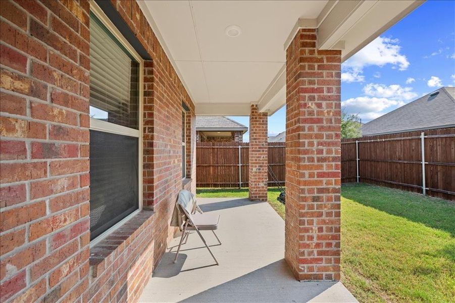 Fenced backyard featuring a patio area Fenced backyard featuring a patio area