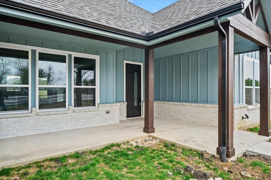 View of exterior entry with a patio