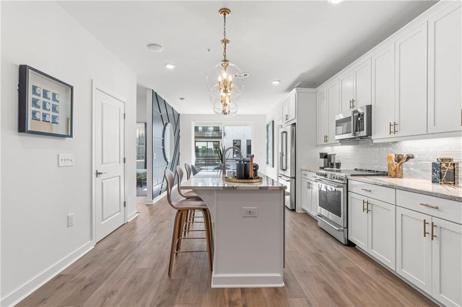 Kitchen opens to the dining area and balcony*Images from the model home. Not subject unit*