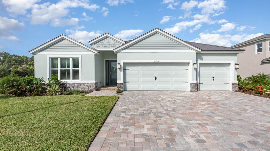 Front exterior of a new home in Riverwalk of Cocoa, Cocoa, FL, highlighting curb appeal (Image 1).