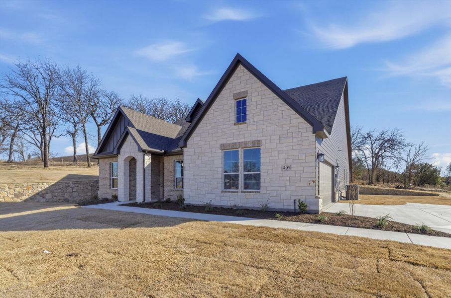 Front exterior of a new home in Oak Grove Addition, Springtown, TX, highlighting curb appeal (Image 20). Front exterior of a new home in Oak Grove Addition, Springtown, TX, highlighting curb appeal (Image 20).