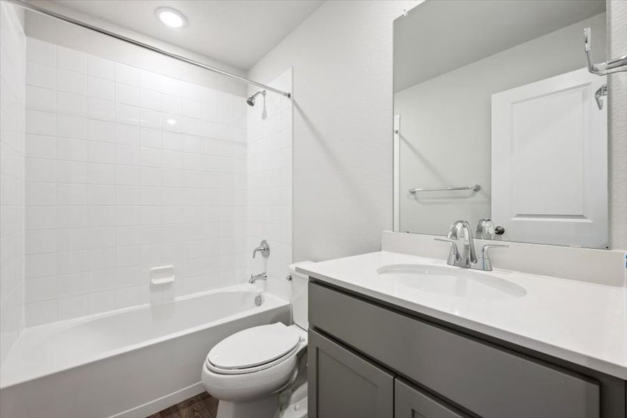 A bathroom with a tub sink and toilet.