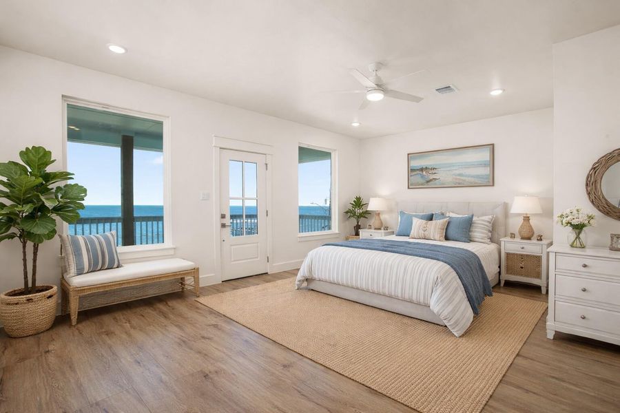 Virtually staged primary bedroom (upstairs) with water view and private deck