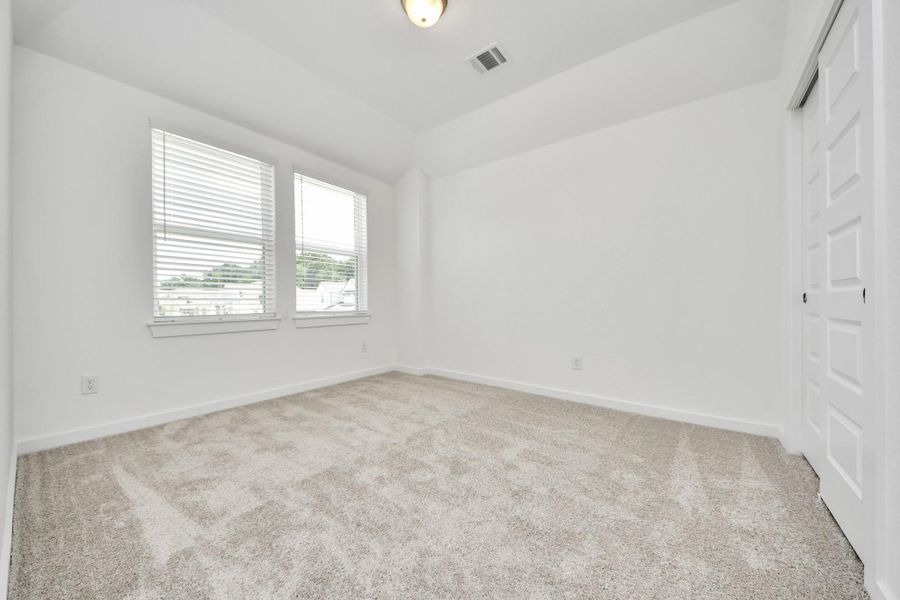 Secondary bedroom features plush carpeting, large windows that let in plenty of natural light, bright paint, and spacious closets. Secondary bedroom features plush carpeting, large windows that let in plenty of natural light, bright paint, and spacious closets.