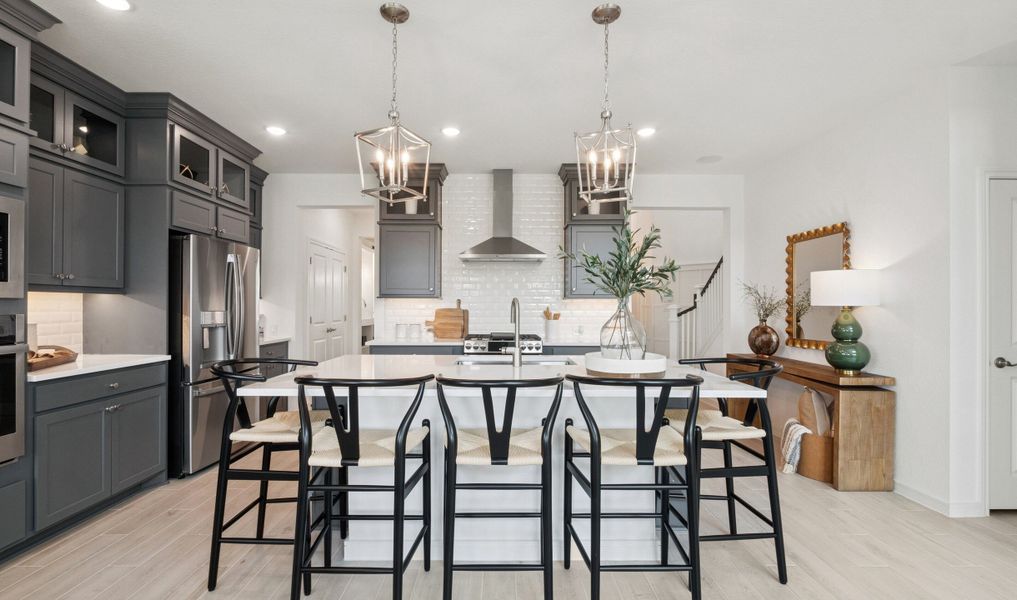 Kitchen showcases stacked cabinetry with glass-front uppers Kitchen showcases stacked cabinetry with glass-front uppers