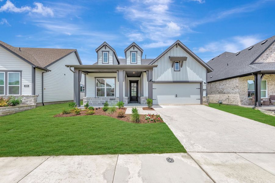 Front exterior of a new home in Pecan Square - Gardens, Northlake, TX, highlighting curb appeal (Image 1). Front exterior of a new home in Pecan Square - Gardens, Northlake, TX, highlighting curb appeal (Image 1).