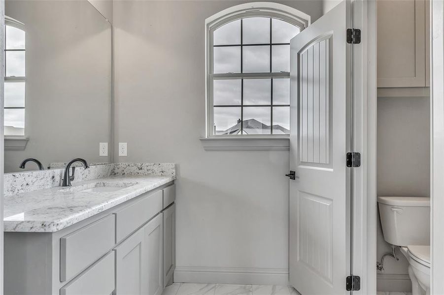 Bathroom featuring vanity and toilet