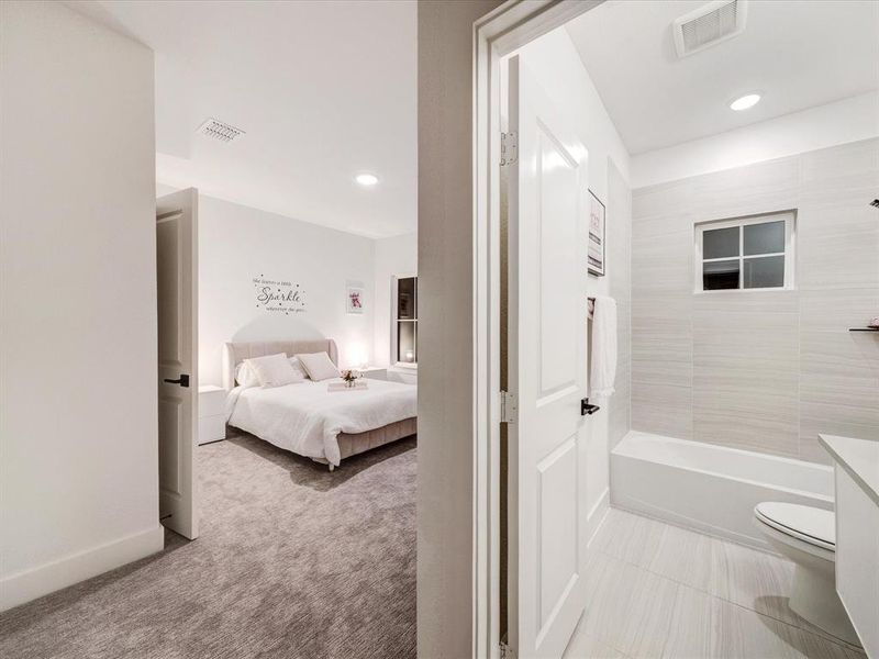 Full bathroom with ensuite bathroom, light colored carpet, recessed lighting, shower / washtub combination, and vanity Full bathroom with ensuite bathroom, light colored carpet, recessed lighting, shower / washtub combination, and vanity