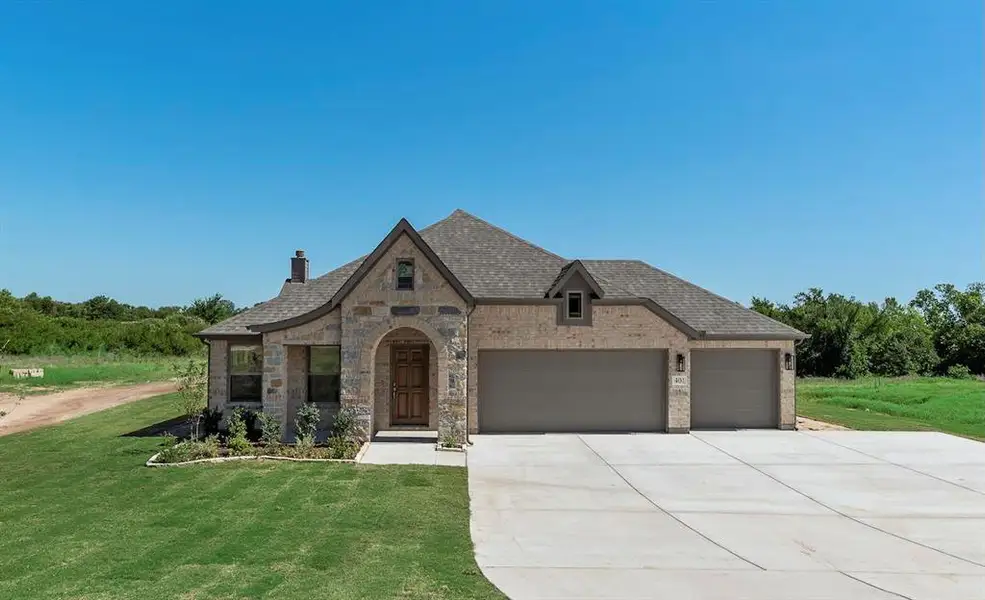 Front exterior of a new home in , Springtown, TX, highlighting curb appeal (Image 1). Front exterior of a new home in , Springtown, TX, highlighting curb appeal (Image 1).