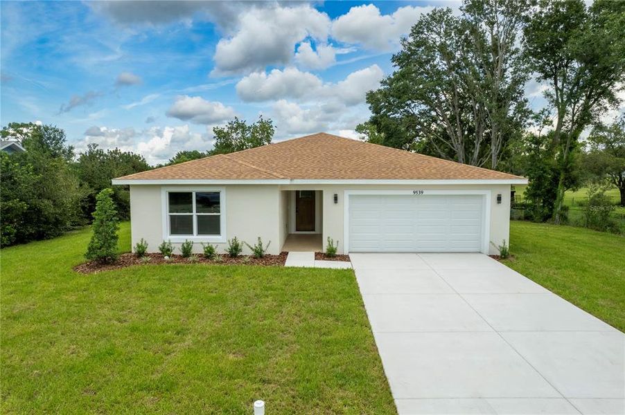 Front exterior of a new home in , Spring Hill, FL, highlighting curb appeal (Image 2).