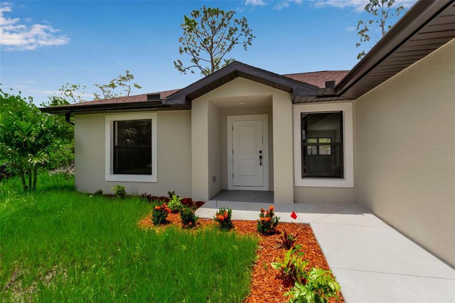 Front exterior of a new home in , Punta Gorda, FL, highlighting curb appeal (Image 22).