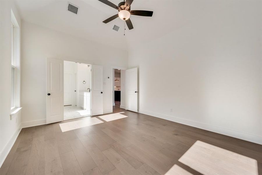 Unfurnished bedroom with wood finished floors and a ceiling fan Unfurnished bedroom with wood finished floors and a ceiling fan