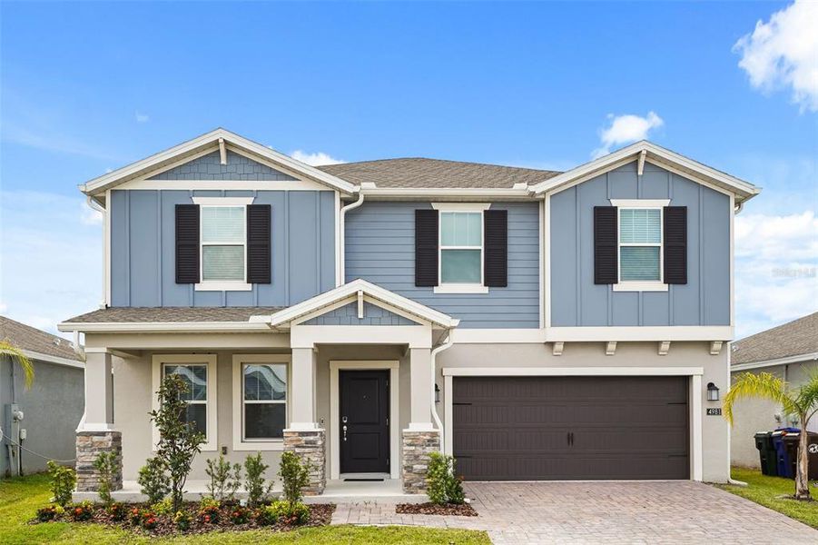 Front exterior of a new home in Knightsbridge, Kissimmee, FL, highlighting curb appeal (Image 1). Front exterior of a new home in Knightsbridge, Kissimmee, FL, highlighting curb appeal (Image 1).